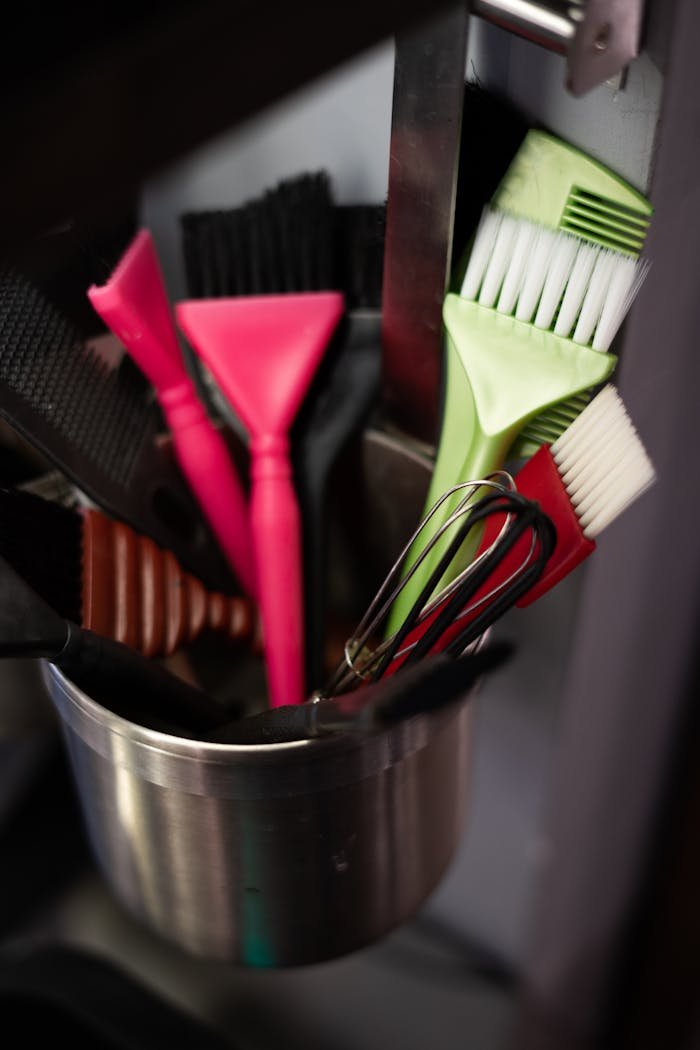 Red and Black Handled Fork in Stainless Steel Bucket